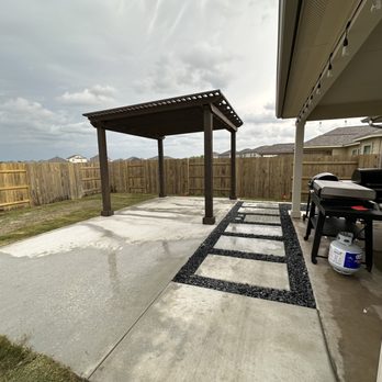Austin Yard Builder - Cedar Wood Pergola and a Concrete Pad with Concrete Step and Black Star Gravel in Austin TX - Landscaping Near Me - Hutto, Texas Austin Yard Builder - Cedar Wood Pergola and a Concrete Pad with Concrete Step and Black Star Gravel in Austin TX - Landscaping Near Me - Hutto, Texas
