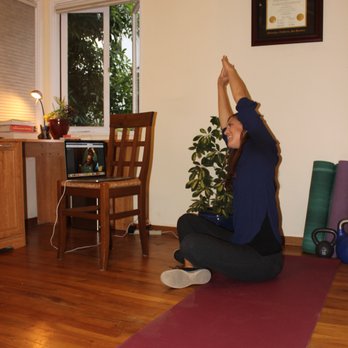 Pregnancy To Performance - Telehealth session with owner, Dr. Annick Lamb showing a stretch to her client through video conference. - Physical Therapy Near Me Pregnancy To Performance - Telehealth session with owner, Dr. Annick Lamb showing a stretch to her client through video conference. - Physical Therapy Near Me