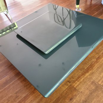 Kaiyo - A glass table with a smaller glass cover on top is situated on a wooden floor, with chairs and other furniture visible nearby. - Furniture Stores Near Me - Chino, California