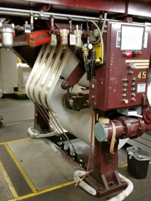 Photo of Tampa Bay Times - Saint Petersburg, FL, US. The rolls of newsprint are "stitched" together and fed up to the third floor to start the printing process.