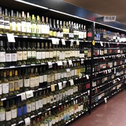 rows of wine bottles in a store rows of wine bottles in a store