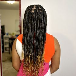 Style Worthy - Medium knotless braids with wavy ends and a touch of color.