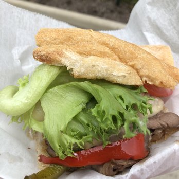 Kenny's Meat Wagon - a hand holding a sandwich - Food Trucks Near Me - Columbus, Ohio
