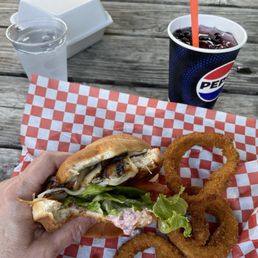 Cross-section of Mount Adams grilled chicken sandwich with onion rings. Cross-section of Mount Adams grilled chicken sandwich with onion rings.