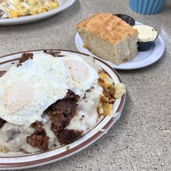 Jeri's Jumbos Cafe - Jumbo's special with hash browns with chicken fried steak bites covered in sausage gravy with two eggs on top!