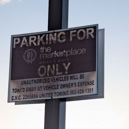 Parking for The Marketplace Grill Cafe customers only. They should consider replacing that sign Parking for The Marketplace Grill Cafe customers only. They should consider replacing that sign
