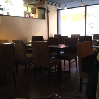 Second Cup - a table and chairs in a restaurant - Coffee & Tea Near Me - Toronto, Ontario