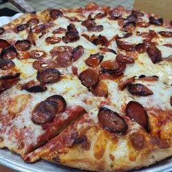Large pizza with sweet sauce.