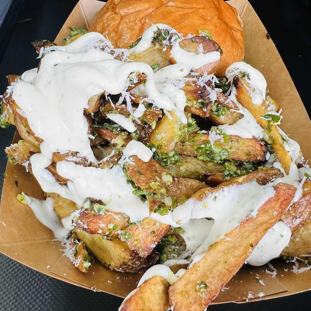 The Hood - Garlic truffle herb mixture on tallow fries with a Pecorino Romano sauce on top. - Food Trucks Near Me - Meridian, Idaho The Hood - Garlic truffle herb mixture on tallow fries with a Pecorino Romano sauce on top. - Food Trucks Near Me - Meridian, Idaho
