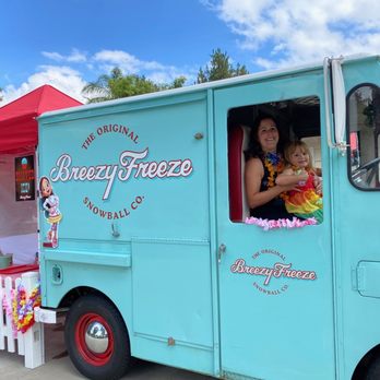Breezy Freeze Snowball Co. - a woman and child in a truck - Shaved Ice Near Me