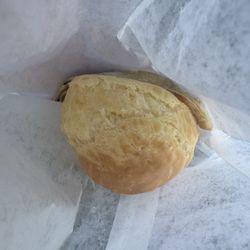 Potomac Village Farmers Market - View of a Brazillian cheese roll & Brazillian empanada in their eco-friendly white paper packaging -- the roll is warm, fluffy, & delicious!