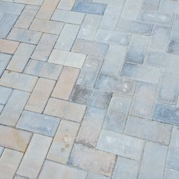 a brick patio with a blue chair