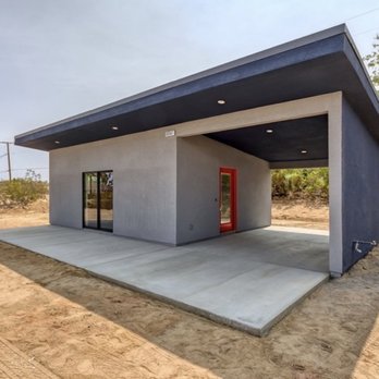 Rauschenberg Construction & Restoration - a concrete building with a red door - General Contractors Near Me - Yucca Valley, California