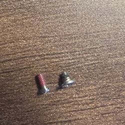LensCrafters - The screw with red on the threads is the one John forced into my glasses. The other one is an original. It is much shorter and fatter.