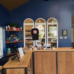 Historic Smoke - Cash register area with the humidor behind it.