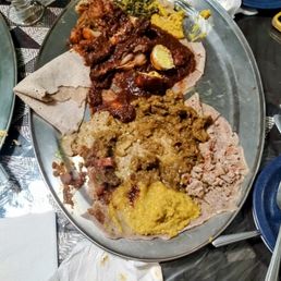 (bad photo)The bottom is the lentils, next up is the lamb stew, up is the national dish of Ethiopia, and there's the collared greens on top.