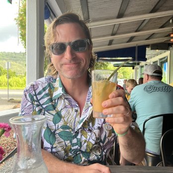 The Dolphin - Great drink though!  Happy guy before his over cooks fish showed up. - Seafood Markets Near Me - Hanalei, Hawaii