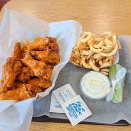 a tray of wings and fries a tray of wings and fries