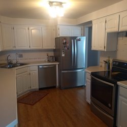 Newcomb Painting and Services - Finished cabinets from wood stain to a beautiful white semigloss.