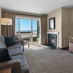 Schooner's Cove Inn - Lower floor oceanfront suite with fireplace and stairs to beachfront lawn from deck.
