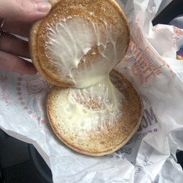 a person holding a half eaten sandwich