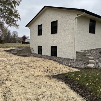 Rejuvenate Landscaping and Design - a white house with black windows - Landscaping Near Me - Princeton, Minnesota Rejuvenate Landscaping and Design - a white house with black windows - Landscaping Near Me - Princeton, Minnesota