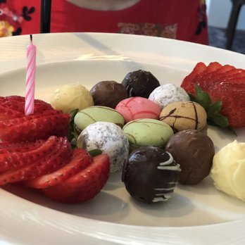 One Bellevue - Top level of noon tea. Strawberries, macaroons and chocolate truffles - New American Near Me - Newport, Rhode Island One Bellevue - Top level of noon tea. Strawberries, macaroons and chocolate truffles - New American Near Me - Newport, Rhode Island
