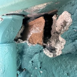 Damaged stucco and a poor repair attempt.