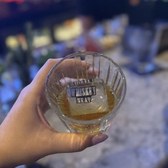 Whiskey Neat - a person holding a glass of whiskey - Whiskey Bars Near Me - Plantation, Florida Whiskey Neat - a person holding a glass of whiskey - Whiskey Bars Near Me - Plantation, Florida