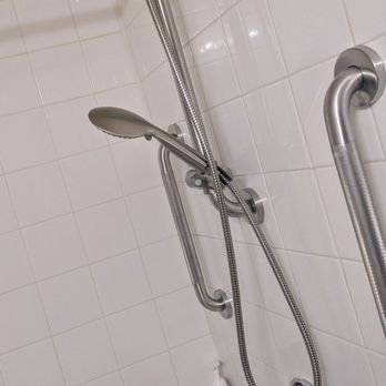 ARD Home Services - Handheld shower & bars. The tile shelf runs full length. A very nice touch & easy for Mom swivel chair - General Contractors Near Me