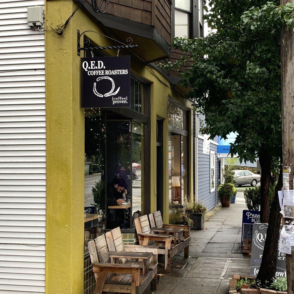 QED Coffee - Waking up to the shop from the sidewalk. - Coffee & Tea Near Me - Seattle, Washington QED Coffee - Waking up to the shop from the sidewalk. - Coffee & Tea Near Me - Seattle, Washington