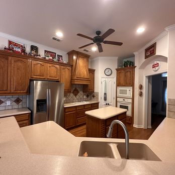 Thompson & Boys - a kitchen with a ceiling fan - General Contractors Near Me