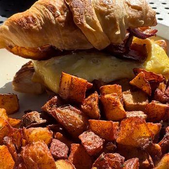 La Croisette - Bacon egg and cheese croissant with crepe in background - Breakfast & Brunch Near Me - St. Pete Beach, Florida La Croisette - Bacon egg and cheese croissant with crepe in background - Breakfast & Brunch Near Me - St. Pete Beach, Florida
