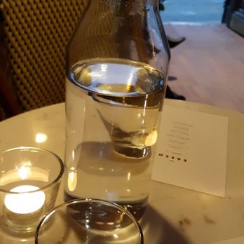 Saeso - Foreground: intimate seating with flickering candle. Background: the manager I mentioned earlier seated to the side front of the entrance - Cocktail Bars Near Me - Cincinnati, Ohio