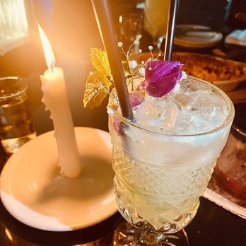 Westend - a glass of alcohol with a candle in the background - New American Near Me - Costa Mesa, California Westend - a glass of alcohol with a candle in the background - New American Near Me - Costa Mesa, California