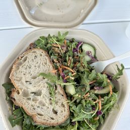 a bowl of salad and a sandwich
