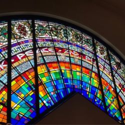 Doors Open - Stained glass with the translation of "Rodef Shalom"....Seek peace and pursue it.