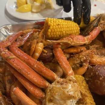 Craving Crab Haus - Family Tray with my son going in for more before I could take my pic. - Cajun/Creole Near Me - Riverside, California