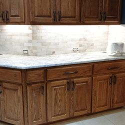 Mena Stone Surfaces - Custom tile installation. With granite countertops in leather finish.