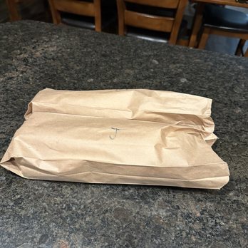 Stateline Subs and Pizza - a paper bag on a table - Pizza Near Me - Post Falls, Idaho