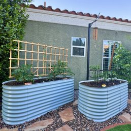 Raised garden beds, flag stone, irrigation, custom iron pole I'll be attaching my grape vines to and synthetic turf