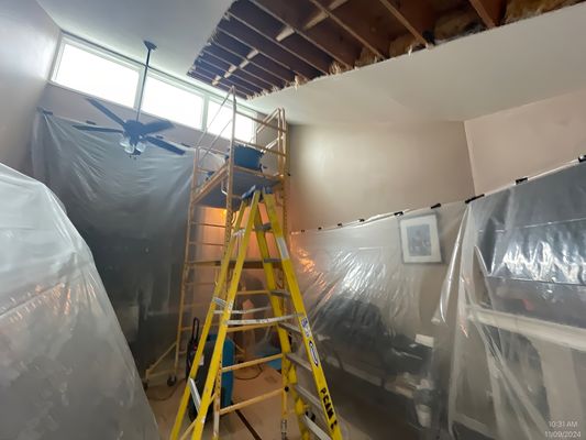 Water Leak Repair - A client called us with a leak in the ceiling in their living room; upon further inspection, it was determined that the roof was leaking from shingles that had blown off in a windstorm. We worked with the roofer to stop the leak.  Once that was completed, we tested the entire ceiling to see where the water was. We set up containment, removed wet sheetrock and insulation; then we set the fans and dehumidifiers to dry the structure over four days. Once dry, we installed new insulation and sheetrock, then mud, tape, and texture and painted the ceiling to match the existing ceiling.