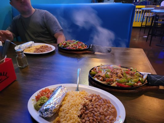 Photo of Paradise Cantina - Las Vegas, NV, US. a man sitting at a table with plates of food