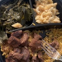 Del's Kitchen - Stew beef over yellow rice, collard greens and macaroni and cheese