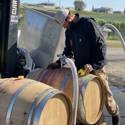 Amos Rome Vineyards - Winemaker Travis barreling wine.