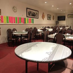 Dining area with Specials on the wall in Chinese.