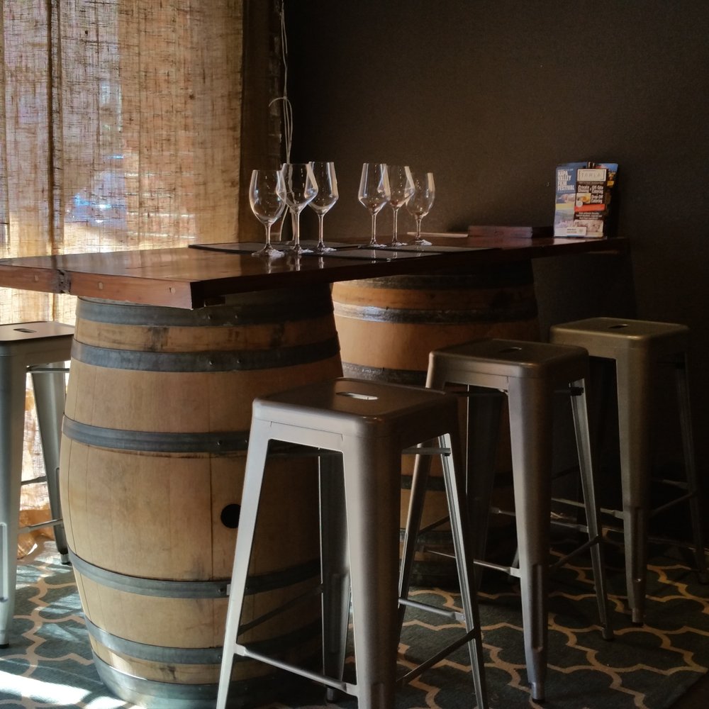 Prime Cellars - a wine barrel with wine glasses on top - Wineries Near Me - Napa, California