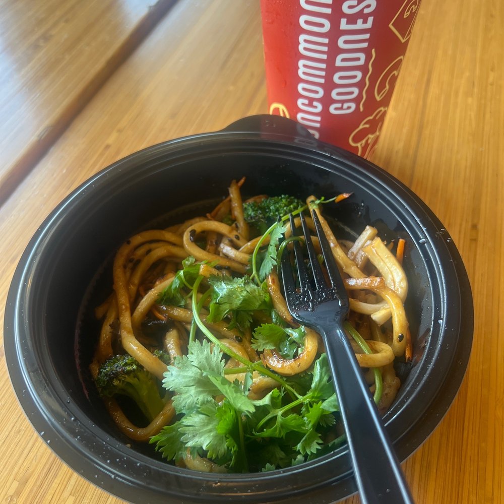 Burned noodles! 3 pieces of broccoli with cilantro  on top.