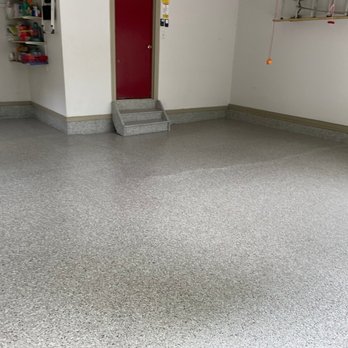 Concept In Concrete - a garage with a red door - Flooring Near Me - Bristol, Pennsylvania