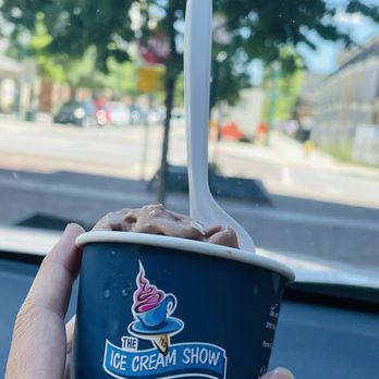 The Ice Cream Show - a hand holding a cup of ice cream - Ice Cream & Frozen Yogurt Near Me - Chattanooga, Tennessee The Ice Cream Show - a hand holding a cup of ice cream - Ice Cream & Frozen Yogurt Near Me - Chattanooga, Tennessee